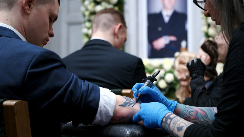 Tattoo artist working on a client during a private event